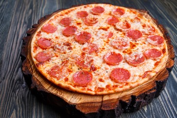 Delicious fresh baked pizza with pepperoni and cheese, close up. Italian traditional cuisine, fast food.