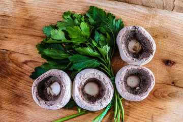 Parsley and mushrooms on he cutting board.