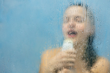 Relaxed carefree woman washes herself in douche, sings loudly, pretends to be successful talented...