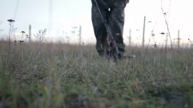 Man with a Metal Detector . Men with metal detector looking for coins and valuables .
