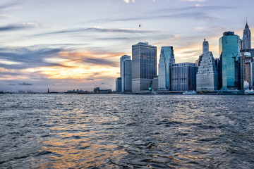 View of outside outdoors in NYC New York City Brooklyn Bridge Park by east river, cityscape skyline during sunset, statue of liberty - obrazy, fototapety, plakaty