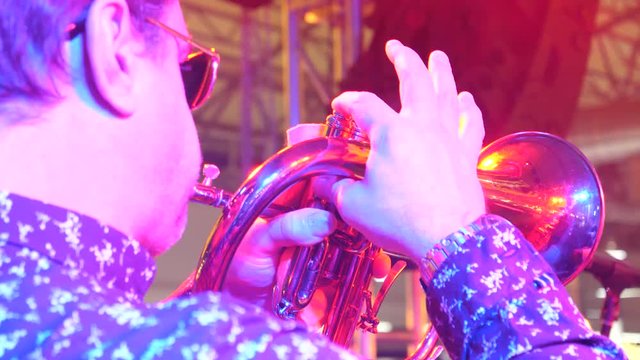 a professional musician plays the trumpet at a concert