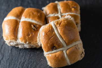Hot Cross buns - tradtional Easter food on grey slate
