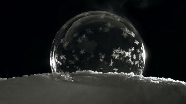 Soap bubble freezing on black bagground