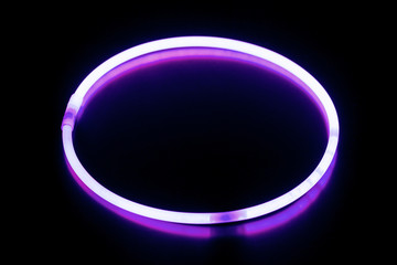 Round violet glow stick bracelet/ Round violet glow stick bracelet on a black surface with reflection