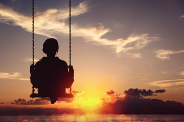 Freedom and carefree of a young female on a swing