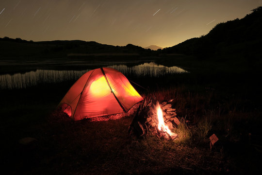 Campfire Near Tent On The Lake In Nebrodi Park, Sicily