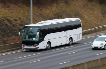 White bus in motion on the motorway