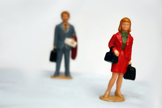 Miniature elegant woman and some man behind her, looking or follow the lady, stalking or sexual harassment concept, admirer, tension in relationship.