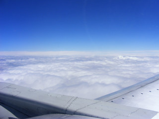 Fototapeta na wymiar Earth and plane wing view from an illuminator
