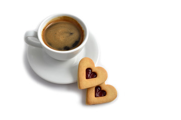 Cookie with coffee stock images. Cup of coffee on a white background. White cup of coffee with snack. Cup of coffee with cookie. Espresso with sweetness. Sweet biscuits hearts