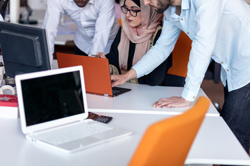 Obraz premium startup business team on meeting in modern bright office interior brainstorming, working on laptop and tablet computer