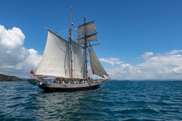 Fototapeta na wymiar Traditional Sailing boat On Calm Blue Seas 