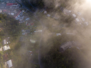Naklejka premium Top Down View Of Fog Covered New Zealand Town 