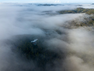 Low Flying Clouds Cover Mountains And Homes In New Zealand in Morning 
