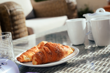 Breakfast on tray served with coffee and fresh flowers on light table background, closeup grocery nutritious balanced diet