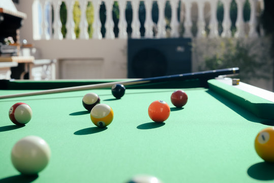 Pool colorful balls on the table sunshine outdoors backgroud. Close up view photo of leisure luxury lifestyle poolgame