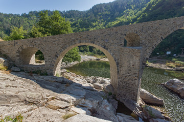 Fototapeta na wymiar Amazing Reflection of Devil's Bridge in Arda river and Rhodopes mountain, Kardzhali Region, Bulgaria