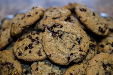 Plate filled with fresh baked Oatmeal Cranberry Cookies.  Sweet delicious hearty snack or treat.