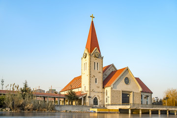 Fototapeta na wymiar A church on the edge of a river in Qingdao