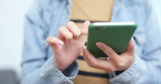 Woman using cellphone to pay the bill