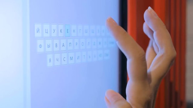 Woman hand using interactive virtual russian keyboard.