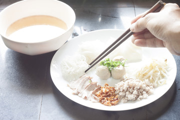 Dried noodles on White plate with soup.