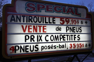 Sign with a special offer for anti-rust and tire service in French speaking Canada