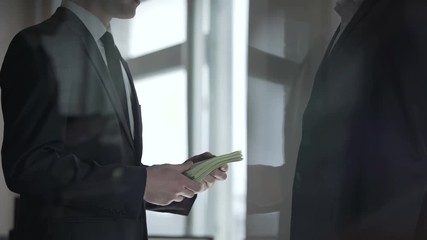 Businessman donating charitable contribution in cash, prosperity of business