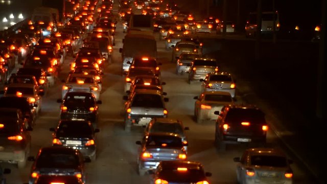 Car traffic jam on the highway. Evening, night, headlight 