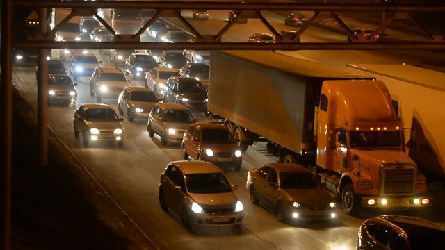 Car traffic jam on the highway. Evening, night, headlight 
