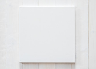 White blank canvas mockup square size on white wood wall for arts painting and photo hanging interior decoration