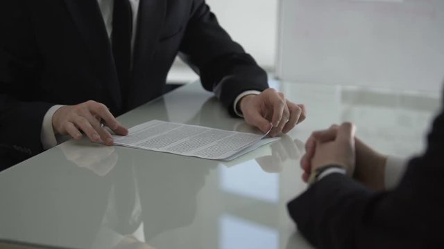 Man looking through contract drawn up by his lawyer and rejecting to sign it