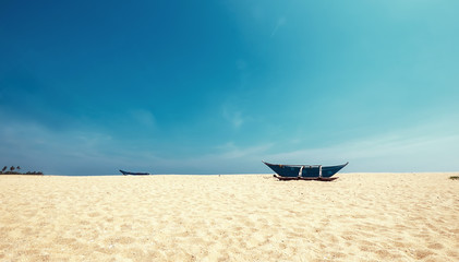 Lonely fishermen`s boat on the sandy beach near the Tangalle , Sri Lanka.