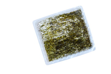 raw seaweed for cooking in plastic tray on white background © pedphoto36pm