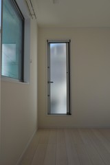 Glass door to exit from the room to the veranda in the residence