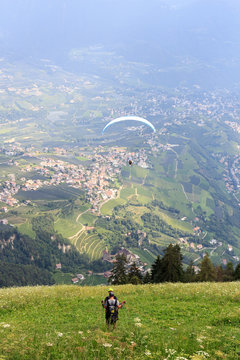 Paragliders start paragliding in front of Tirol panaroma in South Tyrol