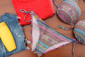 Fototapeta premium Set of beachwear on wooden background