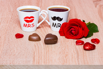 Valentines Day background with two coffee cups, hearts and rose flower