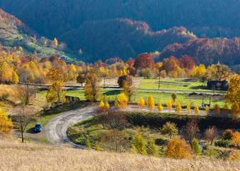 Obraz premium Dirty secondary road in autumn Carpathian mountain, Ukraine