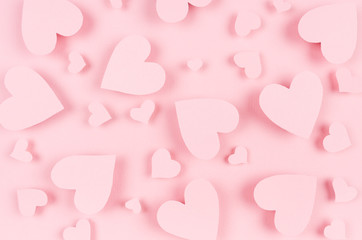 Paper pink hearts fly on soft pink color background. Valentine day concept for design.