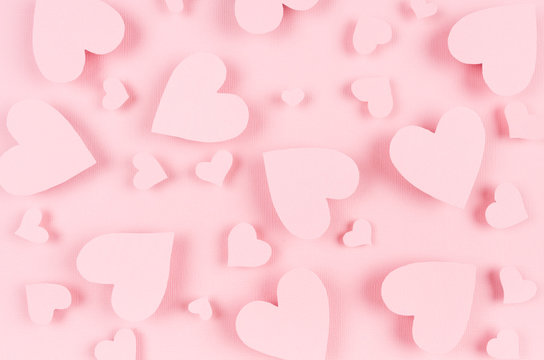 Paper pink hearts fly on soft pink color background. Valentine day concept for design.