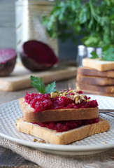 Toast with boiled beets, nuts and fresh parsley