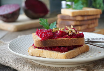 Toast with boiled beets, nuts and fresh parsley