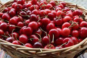 Cherries. Cherry. Organic cherries in basket on a farmer’s market. Red cherry background. Fresh cherries texture. Healthy food concept. 