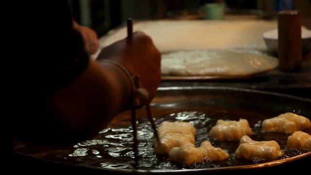 Chef preparing Fried Bread Stick, (youtiao, patongko, Banh Quay)