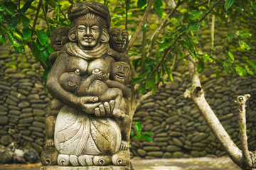 Fototapeta na wymiar Sculpture and religion. Traditional demon statue carved in stone on Bali island, Indonesia.