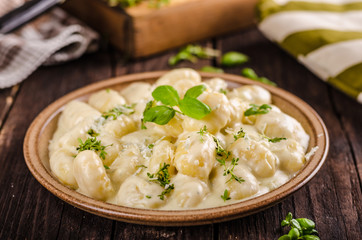 Cheese gnocchi with blue cheese sauce and galic