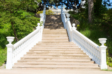 Outdoor staircase with white handrails
