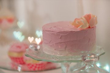 a pink cake is served on a white table for the celebration of St. Valentine's Day